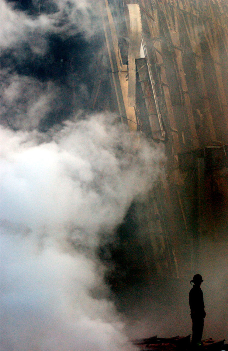 A lone firefighter stands amid the rubble, September 2001 A lone firefighter stands amid the rubble, September 2001